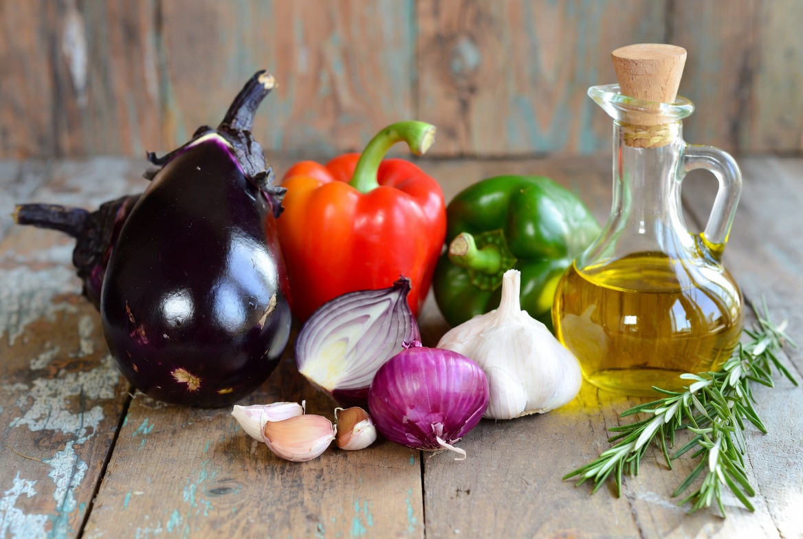 Ingredientes frescos para escalivada: berenjena, pimientos, cebolla, ajo y aceite de oliva